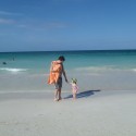 Taking a fun stroll with dad along the shore.