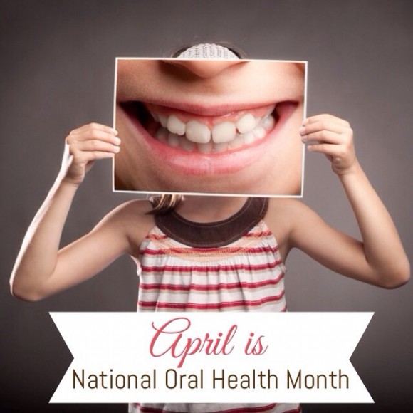 Picture of a girl holding a photo of teeth for National Oral Health Month post